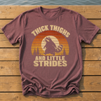 raccoon thick thighs little strides sunset slat T-Shirt — Brick